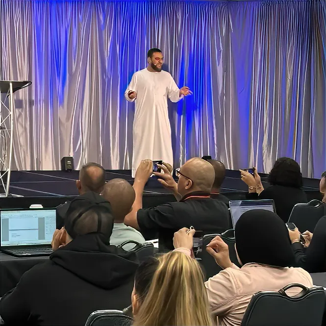 Muhammad Asmal speaking on stage